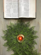 Christmas greenery and open Bible 