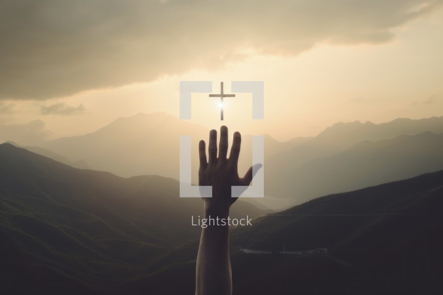 Silhouette of hand and cross in the mountains at sunset