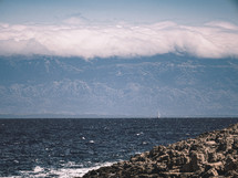 cloud covered mountains by the sea