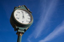 Old fashioned thermometer against blue sky