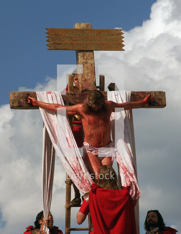 Roman soldiers take down the body of Jesus Christ after being crucified on the cross