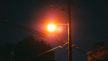street lamp above power lines 