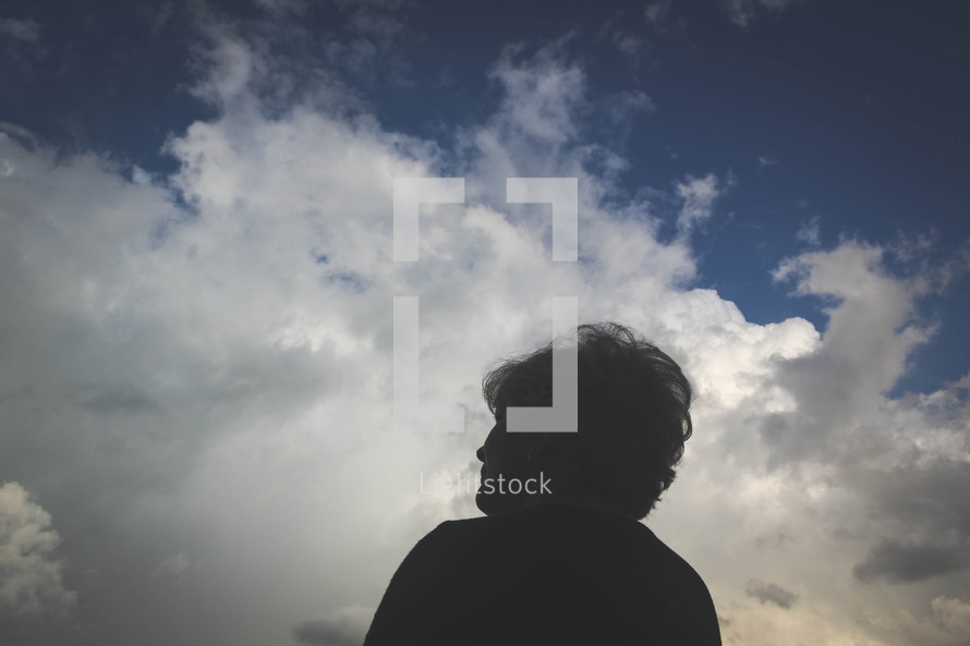 woman looking up at the sky 