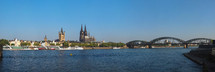 Skyline of the city of Koeln, Germany seen from River Rhein (Rhine). From left to right, the Altstadt (old town), Rathaus (town hall), Dom (cathedral) and Hohenzollern Bridge