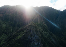 sunbeams over rugged cliffs on a mountainous island landscape 