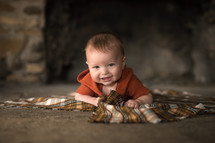 baby on a plaid blanket 