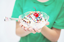 boy child holding a bowl of ice cream 
