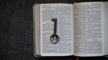 key on the pages of a Bible 