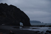 arch through a rock on a beach 