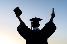 silhouette of a celebrating graduate 