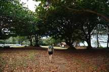 a woman walking through a campgrounds 