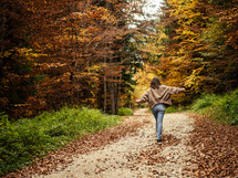 Woman walking on fall path