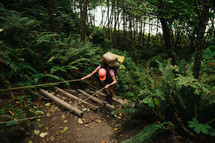 backpacking in a forest and climbing steep wood steps 