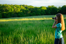 a girl with a camera taking a picture 