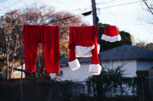 Santa suit hanging on a clothesline 