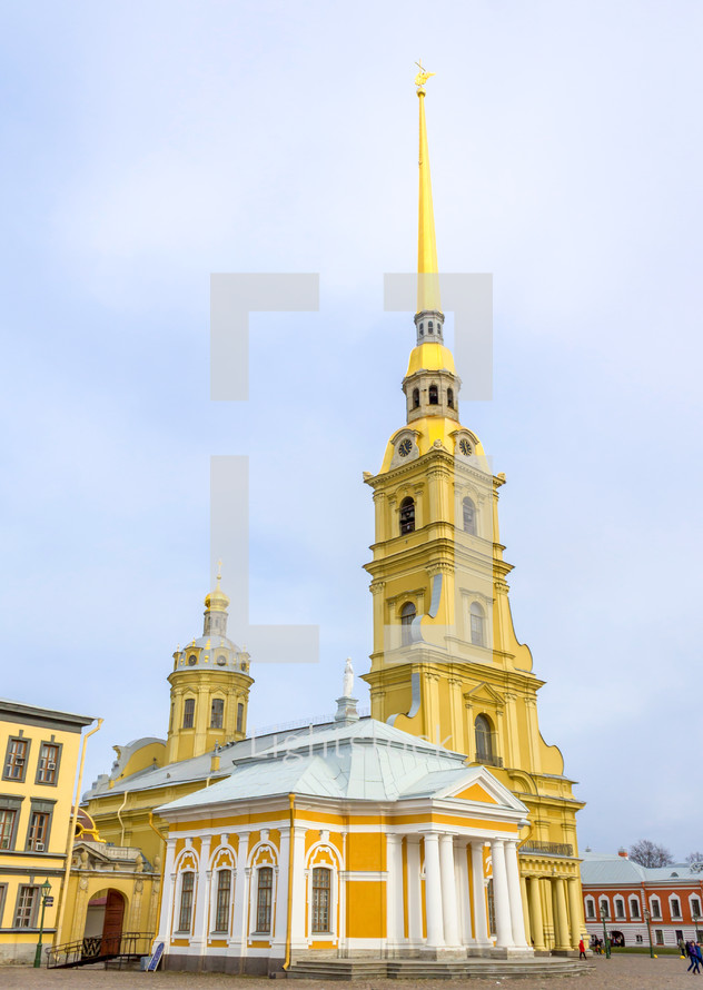 Peter and Paul Cathedral on the territory of Peter and Paul Fortress and tourists walking along in Saint Petersburg, Russia