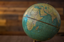 Vintage globe on a classic wood background.