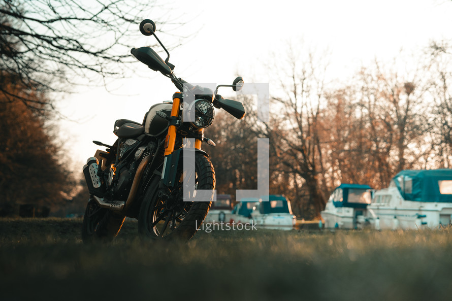 Scrambler motorcycle at sunset, cafe racer style retro motorbike wallpaper
