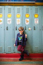 kid standing in front of lockers 
