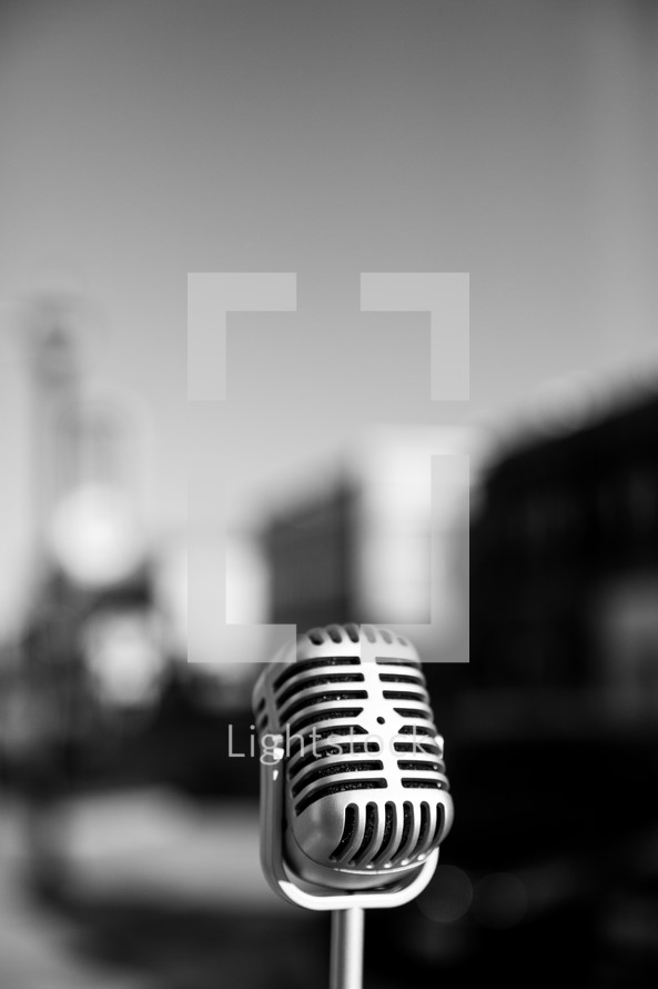 Retro microphone with a city in the background.