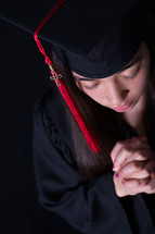 face of a graduate in prayer 