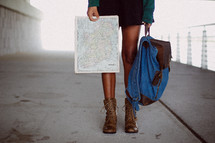 a woman with a backpack and map 
