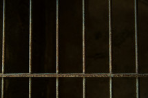 Prison cell bars.