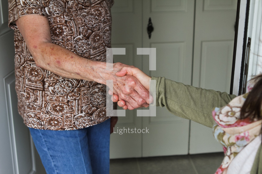 shaking hands with a neighbor 
