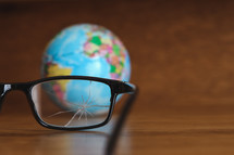 broken glasses and a globe 