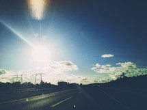 highway and power lines in the sun