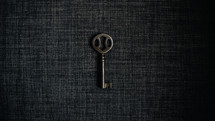 skeleton key on a gray fabric background 
