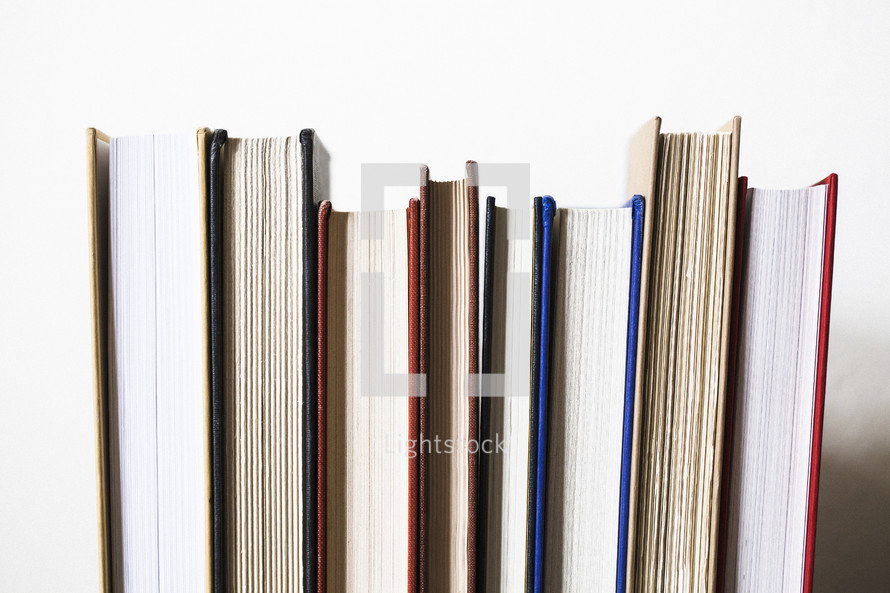 row of books against a white background 