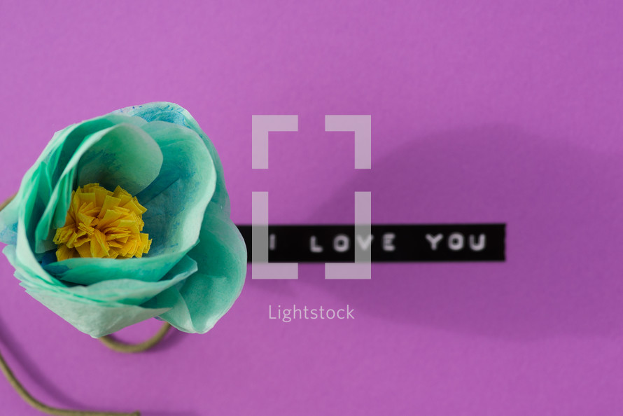 "I love you," on a purple background with a turquoise flower.