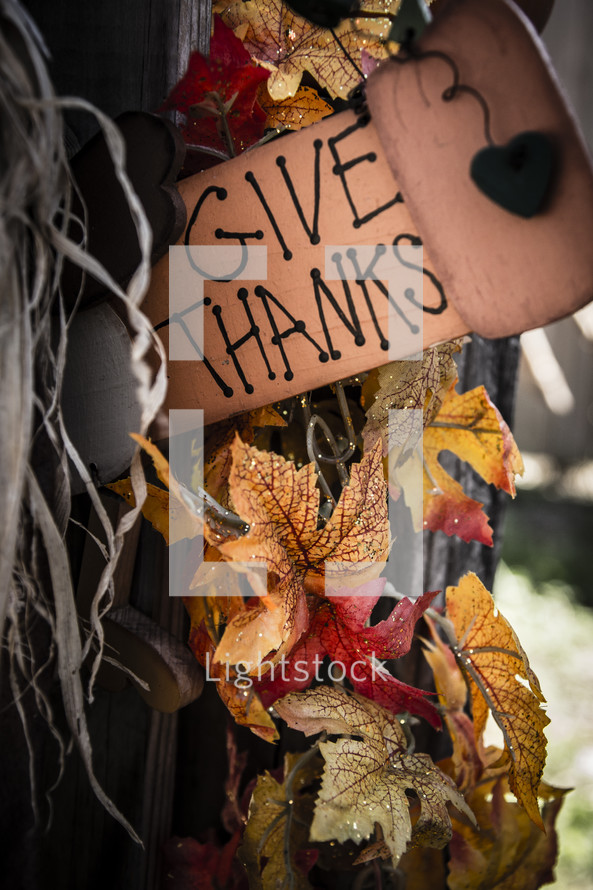 Fall leaves and a sign reading "Give Thanks."