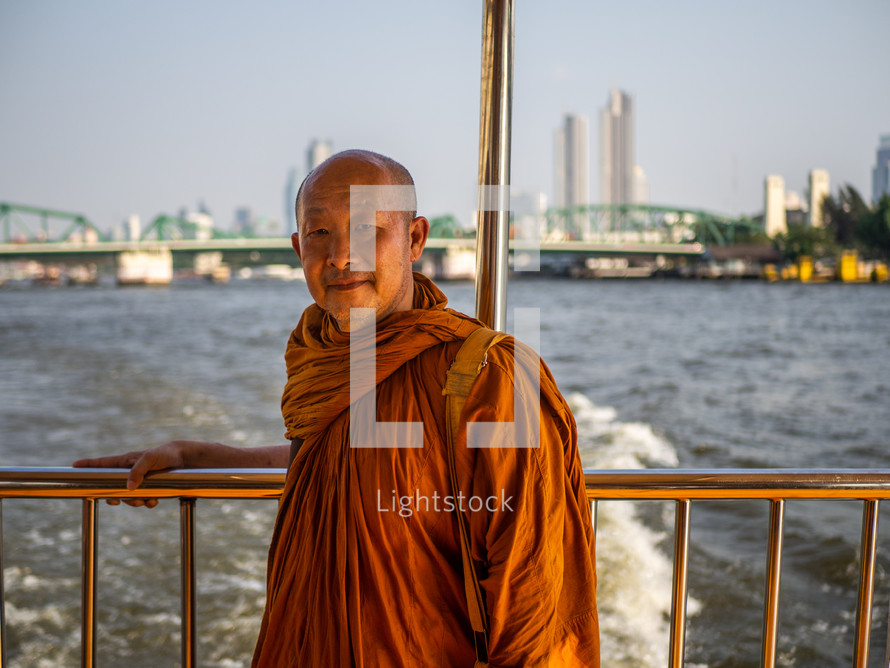 buddhists monk on a boat 