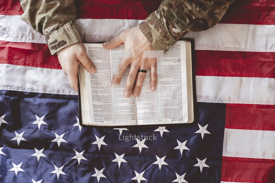 man in military uniform reading a Bible 