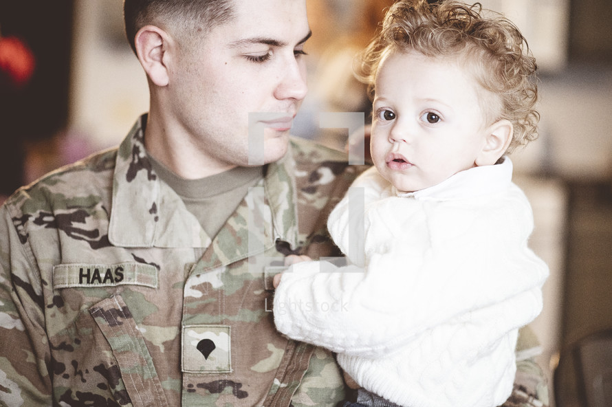 military father holding his son 