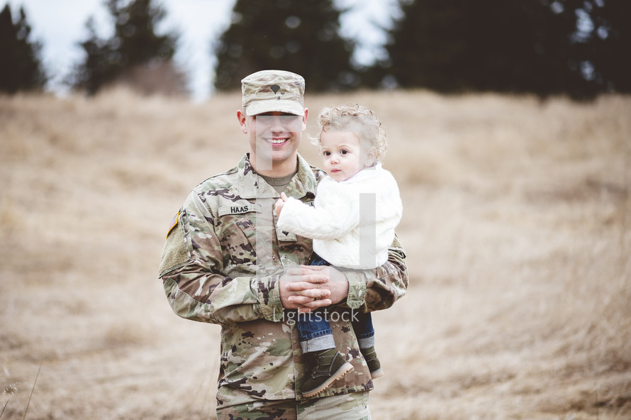 soldier father holding his son 