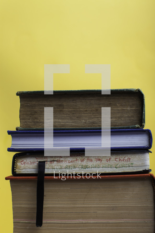stack of books against a yellow background 