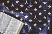 opened Bible on an American flag 