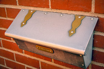 Mailbox on a brick wall.