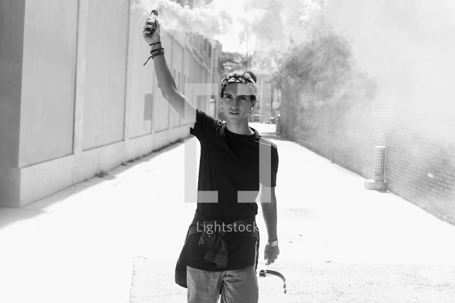a man holding up a smoke flare 