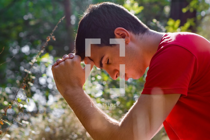 man praying in nature
