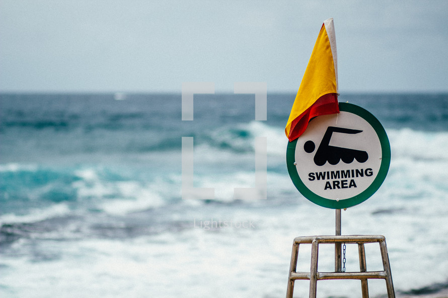 Swimming area sign on a beach 
