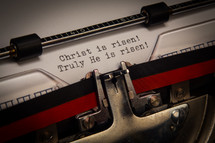 "Christ is risen" typed on paper in a typewriter.