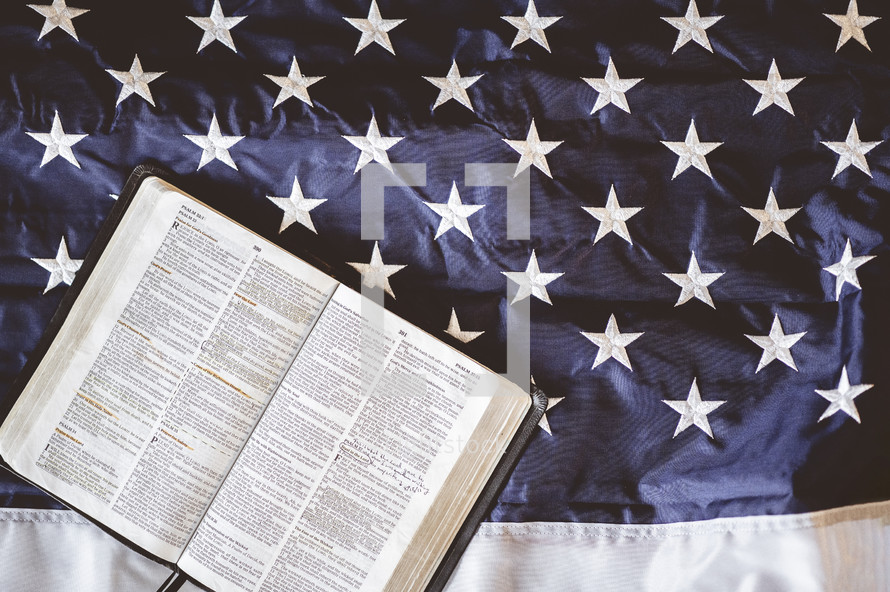 opened Bible on an American flag 