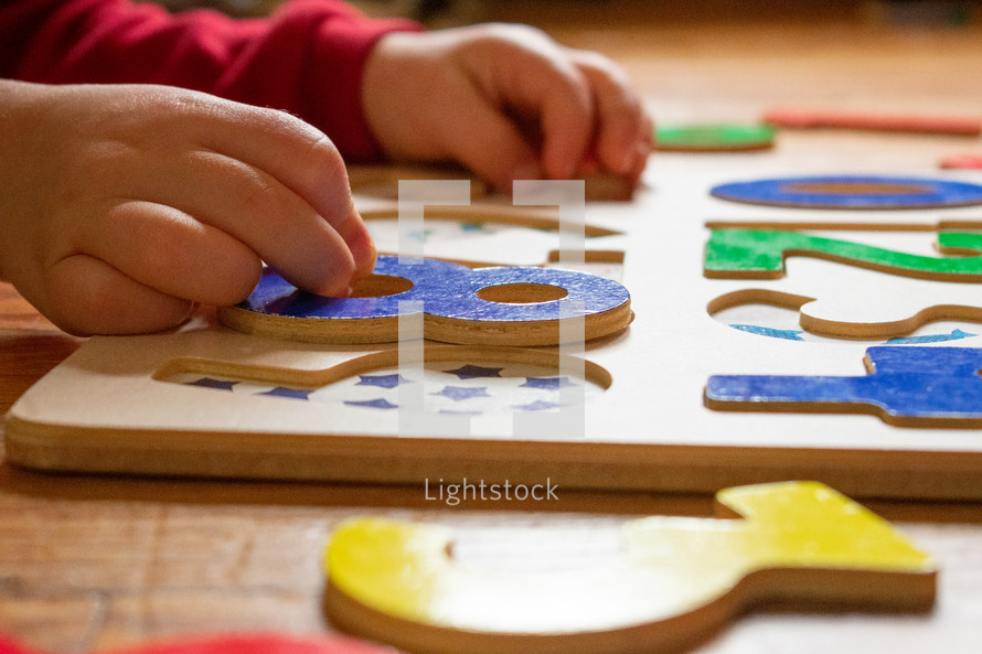 child playing with a puzzle 