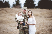 soldier in a field with his family 