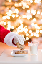 Santa Claus eating Christmas cookies with a bokeh background 