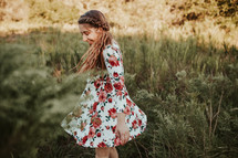 a woman twirling in a meadow 
